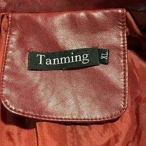 New perfect condition red faux leather jacket. Adorned with zippers and snaps.